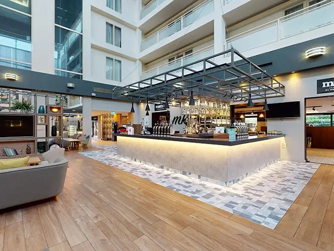 An image showing Holiday Inn Milton Keynes bar area after lighting project completion.